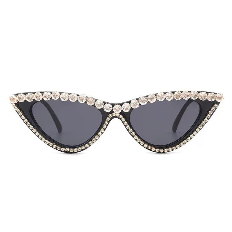 Vintage-inspired cat-eye sunglasses for women, featuring rhinestones. Glamorous accessory with UV protection.