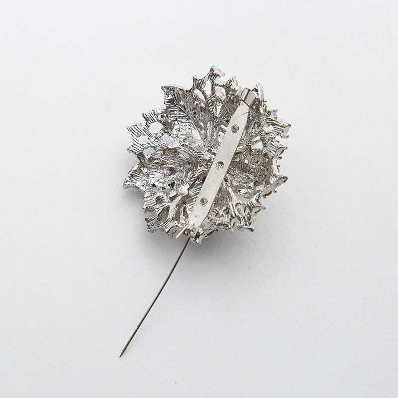 Close-up of a women's glamorous crystal pin, featuring intricate design and brilliant sparkle.