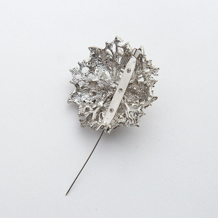 Close-up of a women's glamorous crystal pin, featuring intricate design and brilliant sparkle.