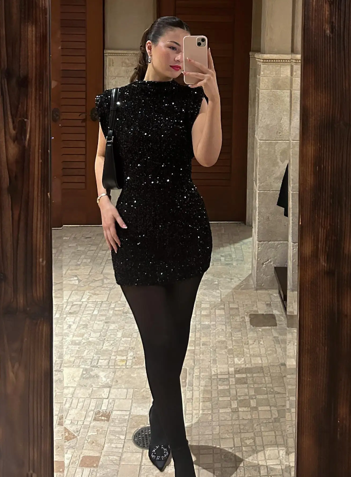 Chic black sequin mini dress for women, ideal as a party or cocktail dress, exuding evening glamour.