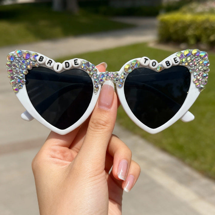 Glamorous women's heart-shaped wedding sunglasses, rhinestone party shades for bachelorette fun.