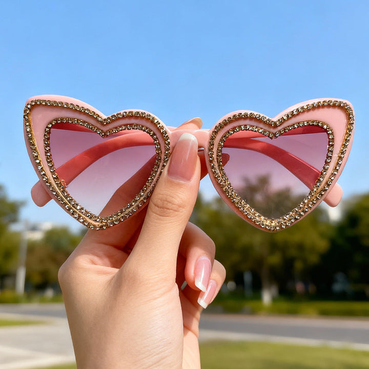 Glamorous Women's Heart-Frame Sunglasses with Rhinestone detail. Trendy summer fashion accessory & UV protection.