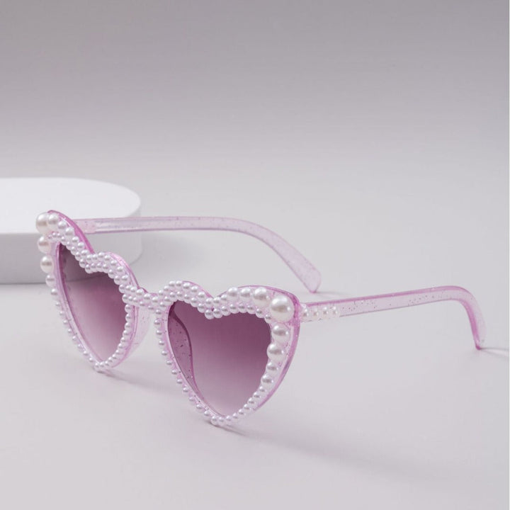 Glamorous women's heart-shaped sunglasses with UV protection, perfect trendy summer eyewear accessory.