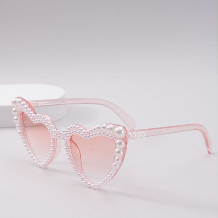 Elegant heart-shaped women's sunglasses featuring delicate pearl accents, trendy fashion accessory.