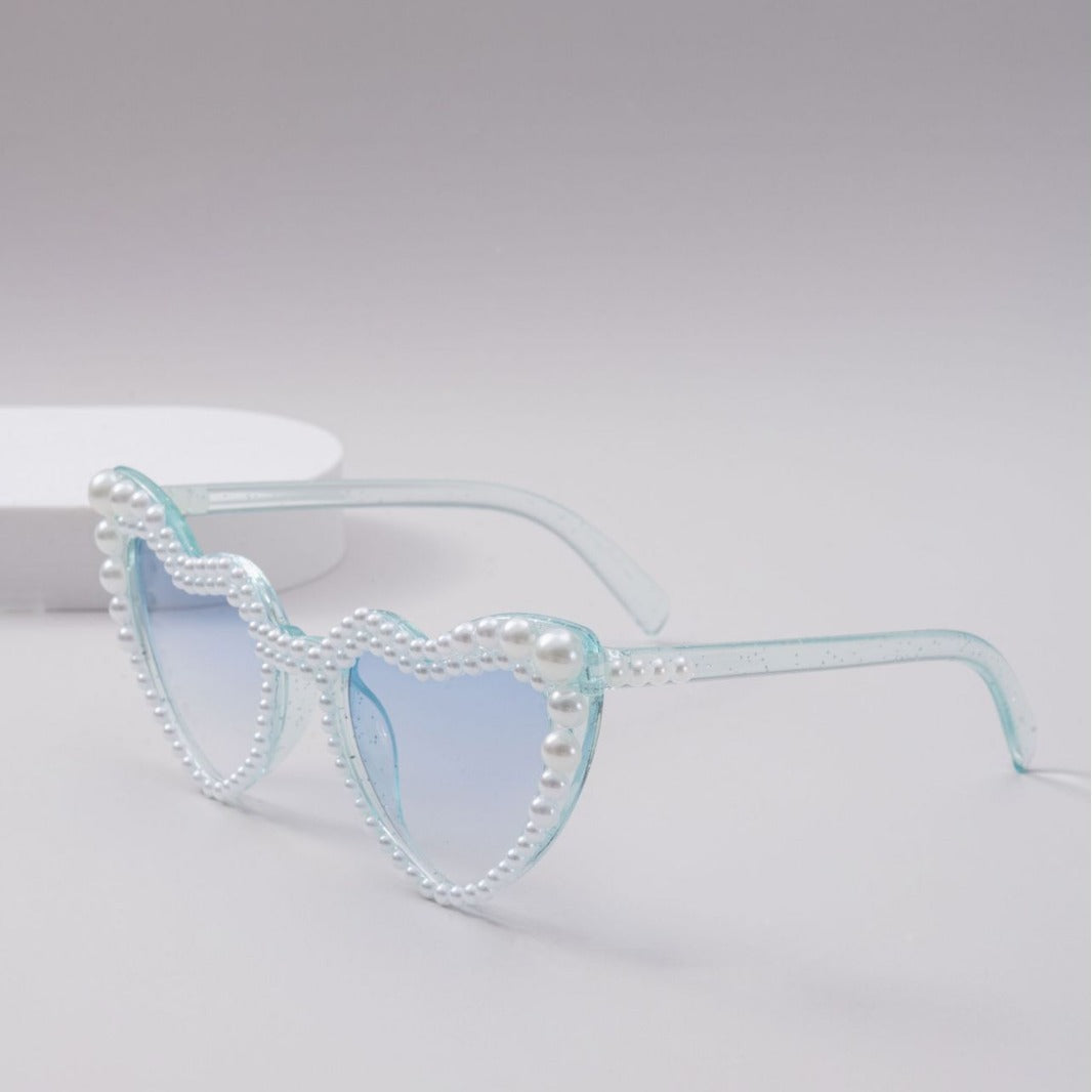 Chic heart-shaped sunglasses for women, offering essential UV protection for stylish summer days.