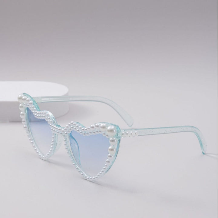 Chic heart-shaped sunglasses for women, offering essential UV protection for stylish summer days.