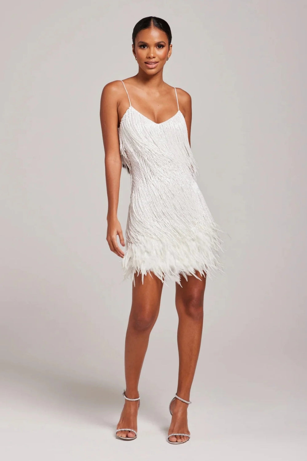 Chic women's cocktail dress, a fitted mini with glamorous fringe & feathers, ideal for evening events.