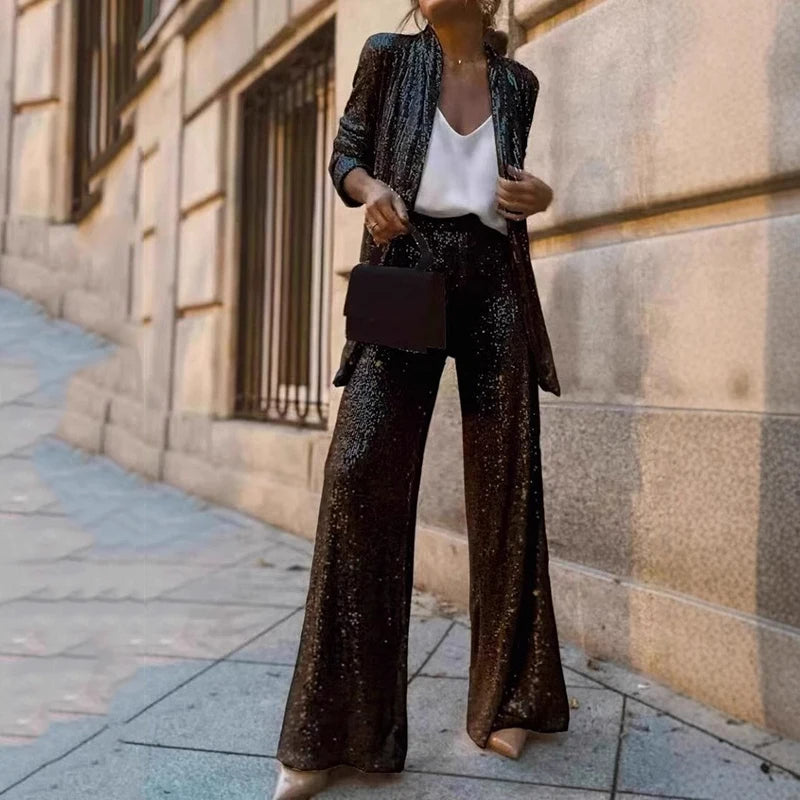 Glamorous women's sequin two-piece set featuring a sparkly top and high-waisted pants, perfect for evening parties.