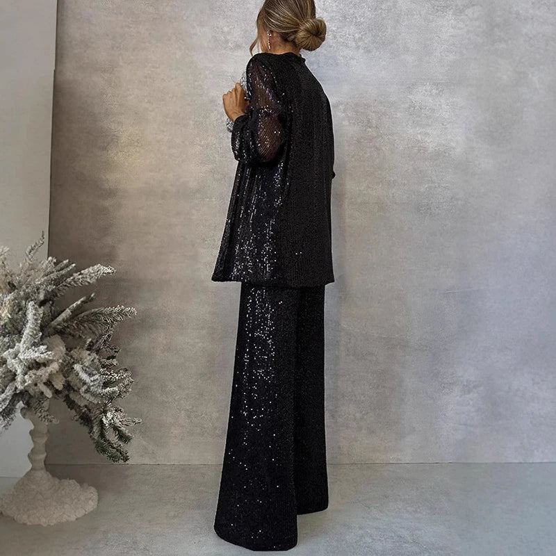 Chic women's sequin two-piece set with a shimmering top and flattering high-waisted pants for statement fashion.