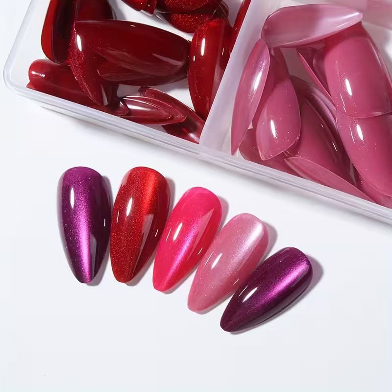 Acrylic press-on stiletto nail tips, long & glossy, ideal for women's nail art and quick elegant makeovers.