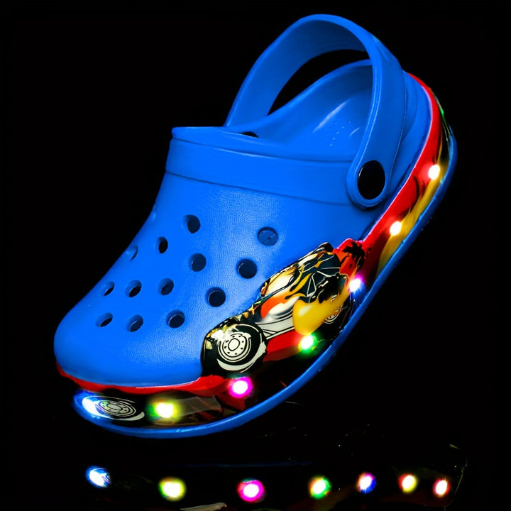 Side profile of boys' slip-on clogs that glow in the dark. Anti-slip & breathable, great for summer outdoor play.