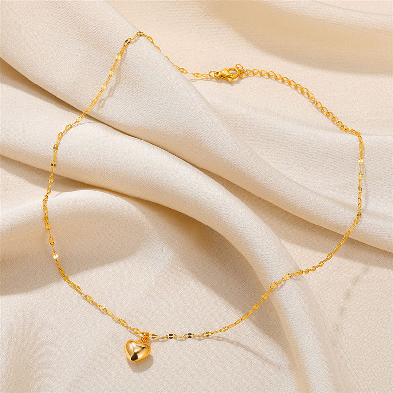 Polished gold-plated heart pendant necklace for women. Delicate design, adjustable chain.