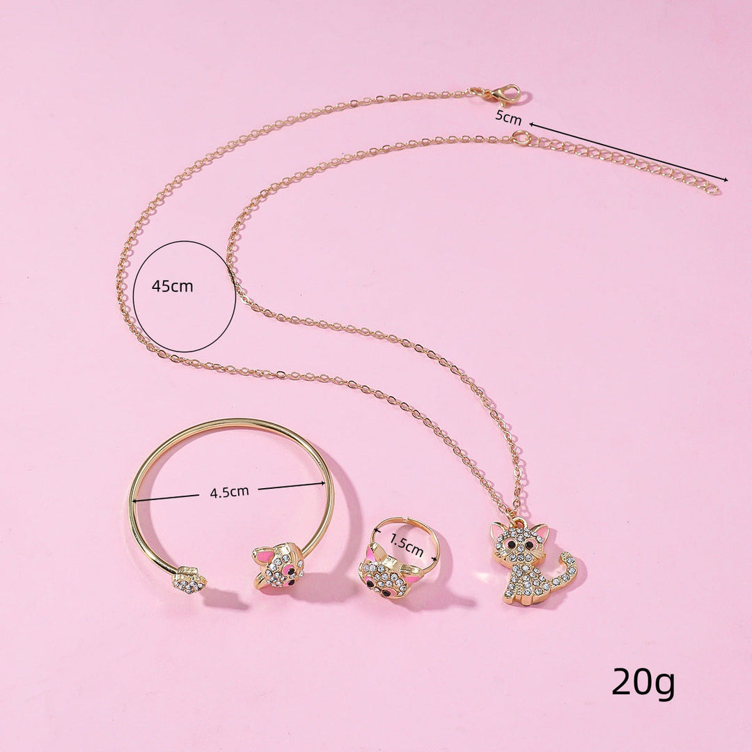 Detailed image of a gold-tone playful cat necklace, ring, & bracelet set. Stylish animal jewelry for women.