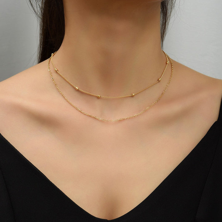 Gold & white layered necklace for women, elegant and delicate everyday wear jewelry.