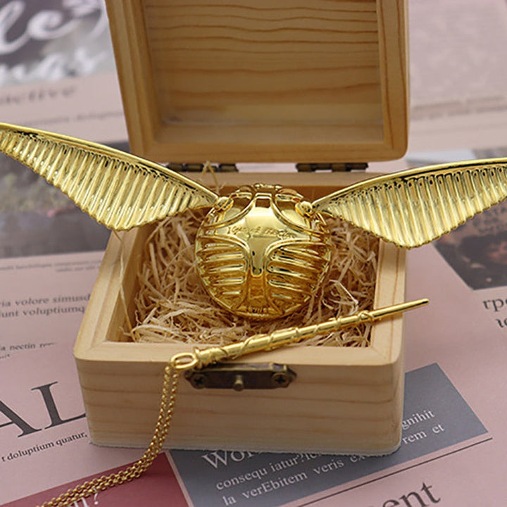 Sophisticated golden winged orb ring box, a movable luxury keepsake for jewelry lovers.