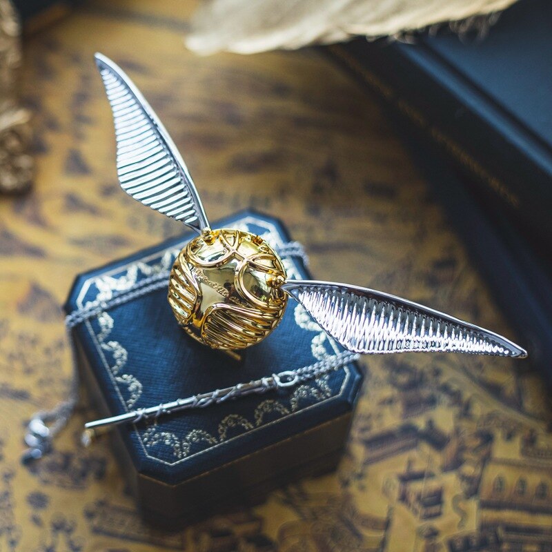 Intricate golden winged orb ring case, a stunning movable fantasy jewelry display.
