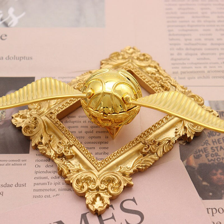 Ornate golden winged orb, a fantasy-inspired movable ring box for special gifts.