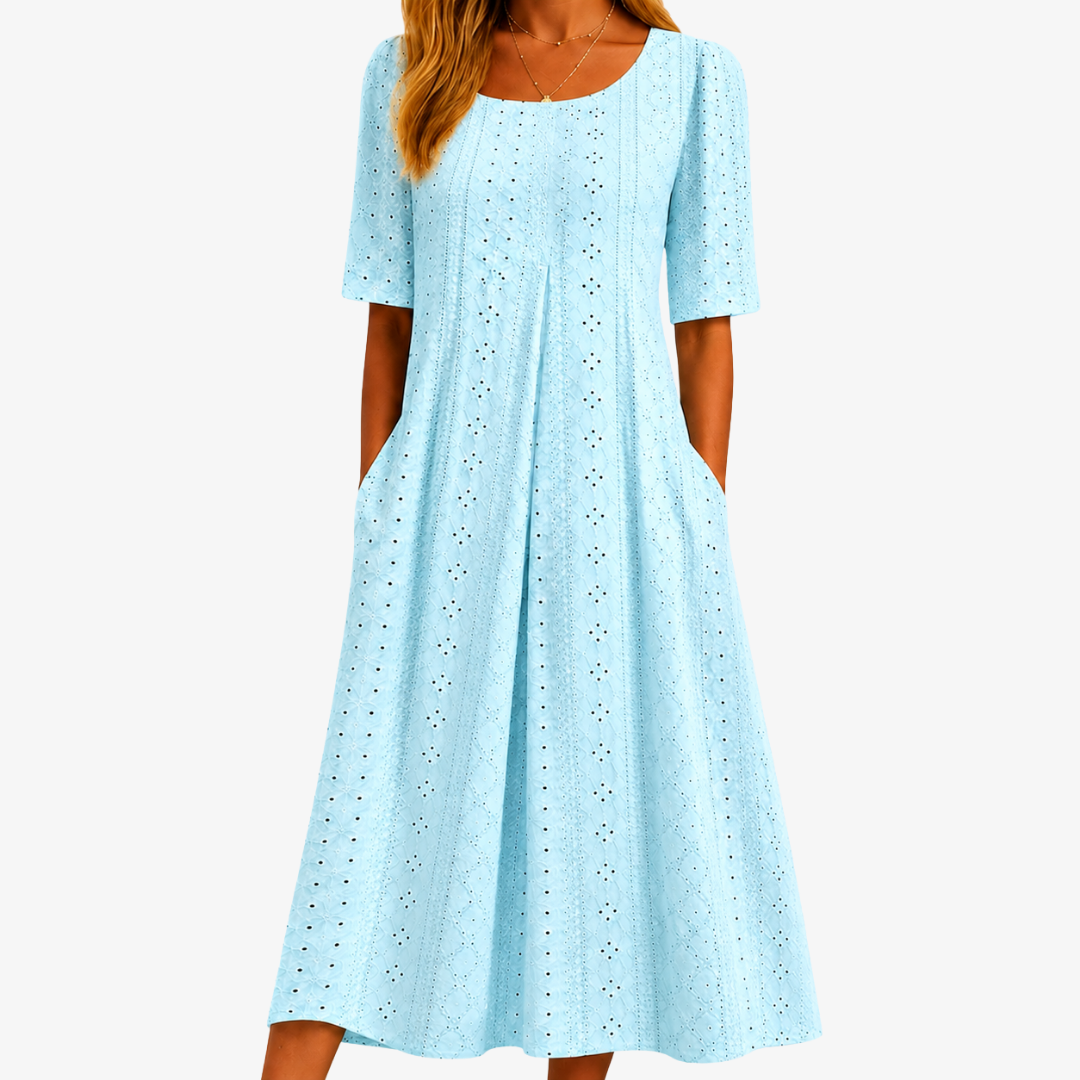 Graceful women's sage eyelet midi dress with pockets. Effortless, comfortable, and flowy for spring & summer fashion.