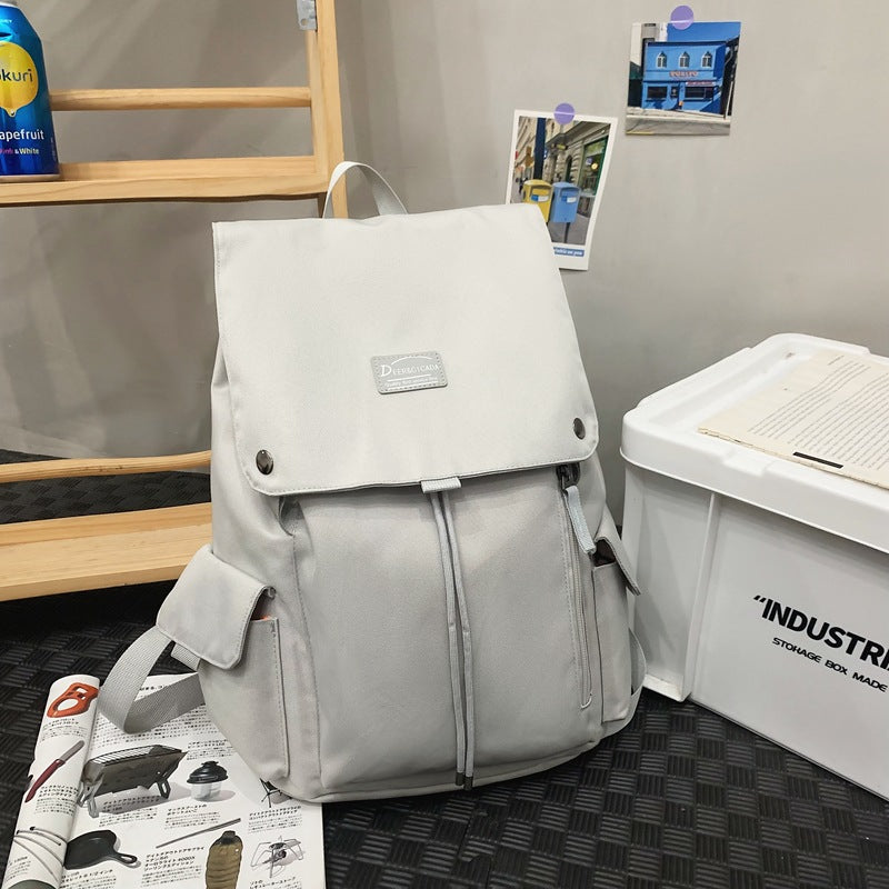 Gray unisex casual everyday backpack, perfect for school, travel, or work. Durable & versatile design.