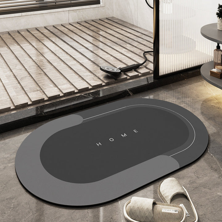 Grey oval bath mat, highly absorbent and non-slip, ensuring a quick-dry, safe bathroom space.