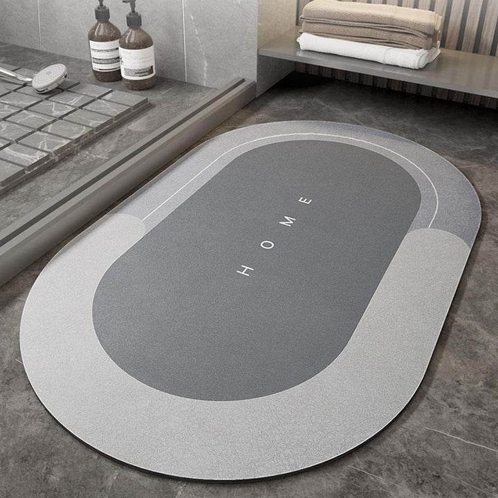 Oval non-slip grey bath mat, soft touch and highly absorbent for elegant bathroom decor.
