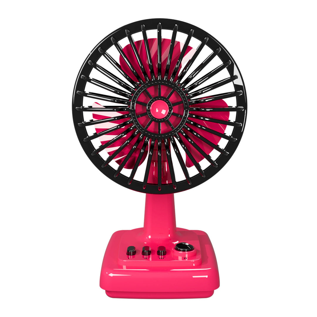 Compact retro desk fan providing personal cooling on a modern home office desk. Ideal small table fan.