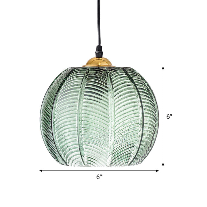 Decorative green ribbed glass pendant light fixture, a beautiful dome-shaped hanging lamp for ambient home lighting.