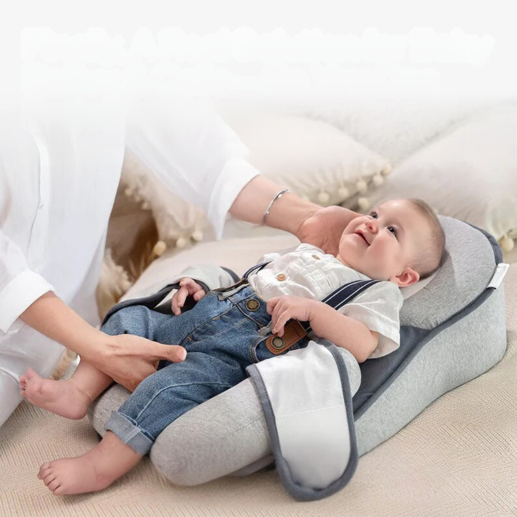 Grey infant anti-reflux sleep support pillow bed, ideal for newborns & babies with colic. Portable sleep nest.