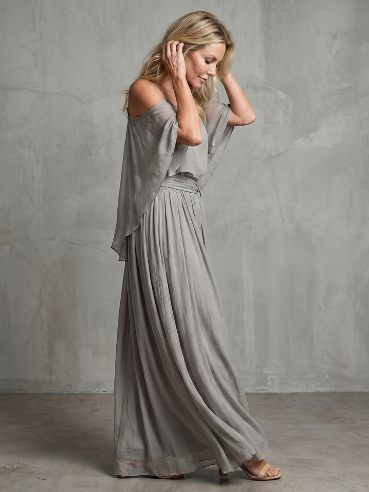 Women's two-piece grey set featuring a layered cold shoulder top and flowy wide leg pants. Casual & chic.