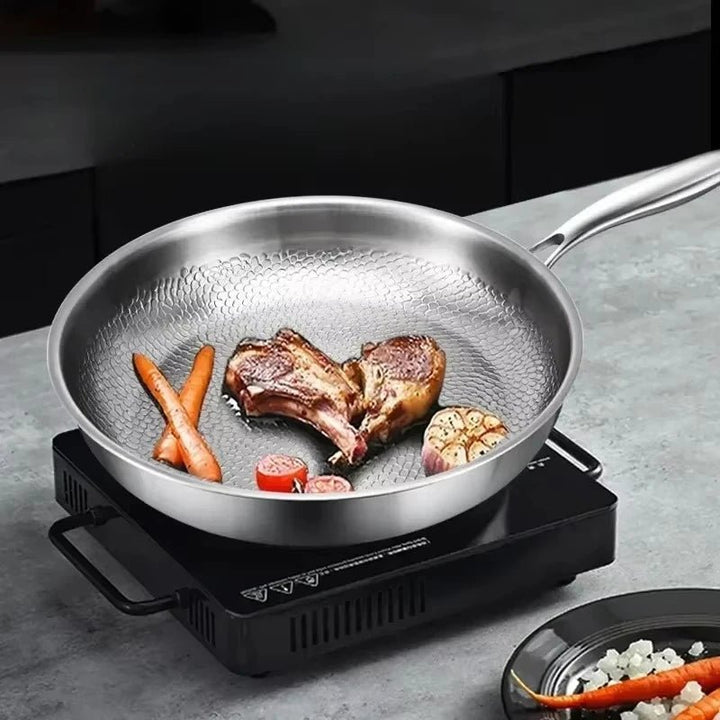 Close-up of the unique hammered texture on a titanium frying pan, perfect for induction cooking.