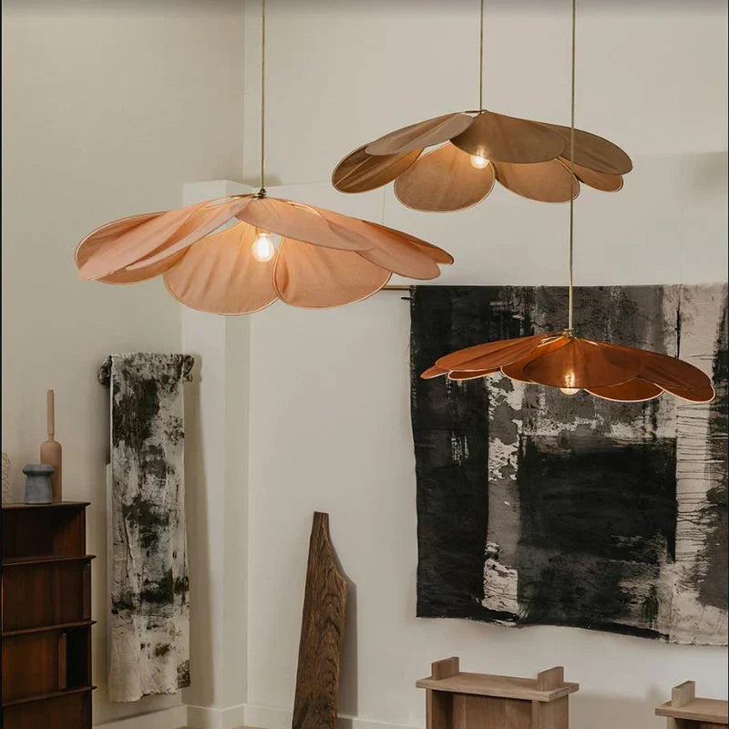 Flower-shaped hand-woven pendant light for natural and boho ceiling decor. Creates warm, ambient lighting.