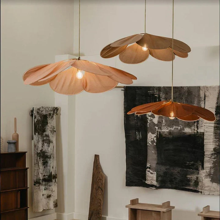 Flower-shaped hand-woven pendant light for natural and boho ceiling decor. Creates warm, ambient lighting.