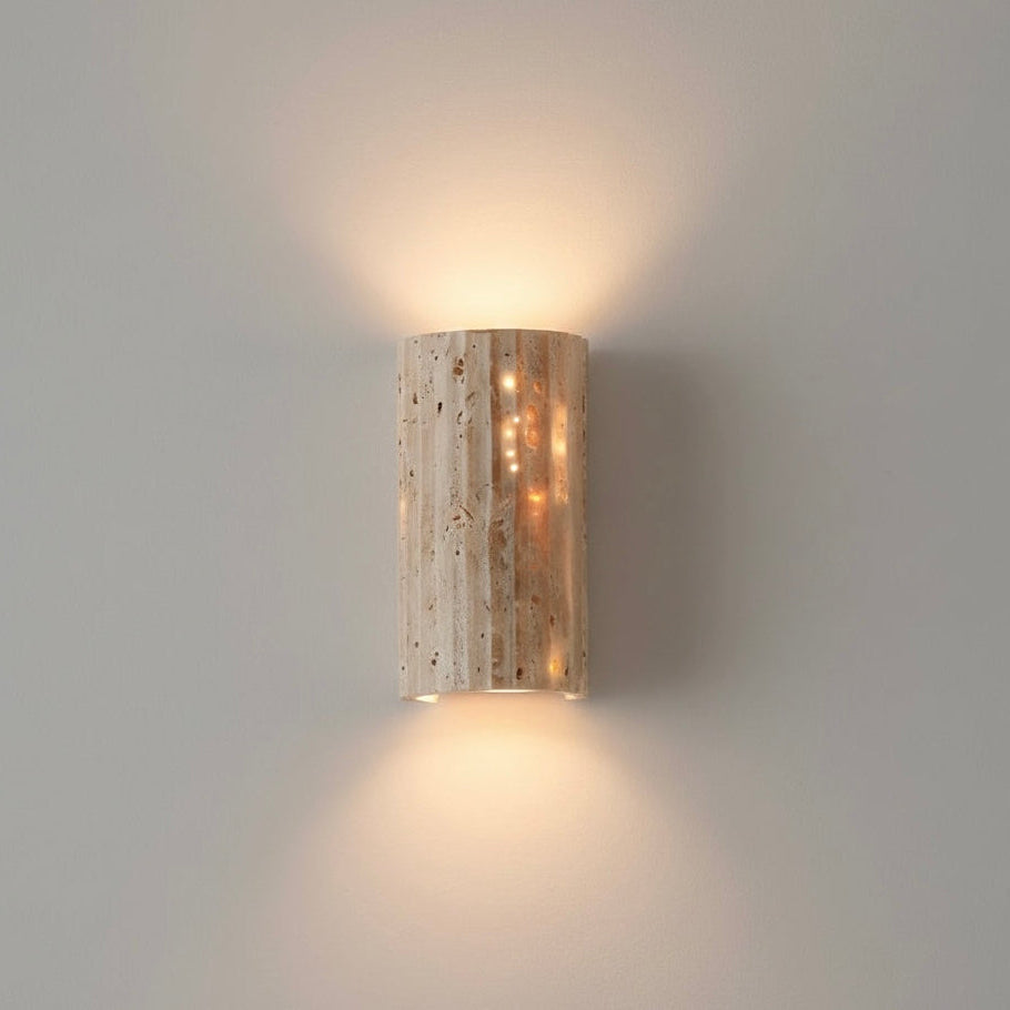 Indoor wall sconce with unique textured surface and warm LED for ambient home lighting.