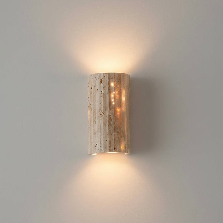 Indoor wall sconce with unique textured surface and warm LED for ambient home lighting.