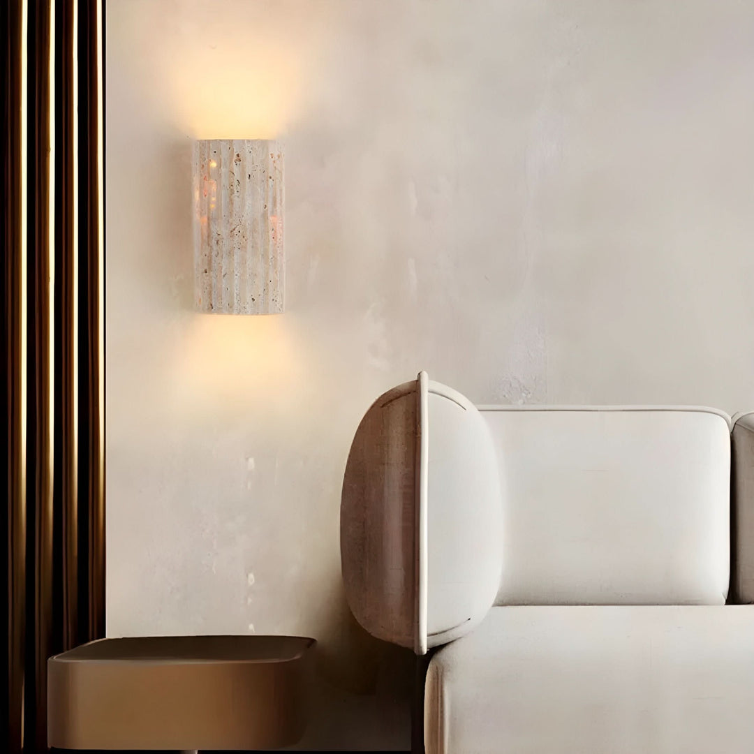 Minimalist indoor wall sconce featuring a unique texture and a warm LED for soft ambient light.