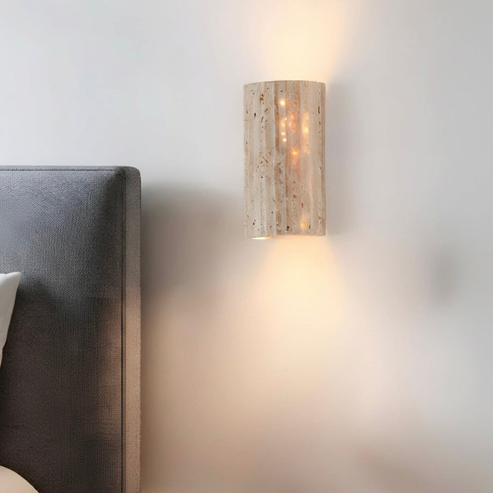 Textured indoor wall sconce with warm LED light, adding a modern touch to any indoor space.