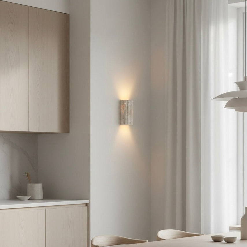 Minimalist indoor wall sconce featuring a unique textured design and energy-efficient warm LED.