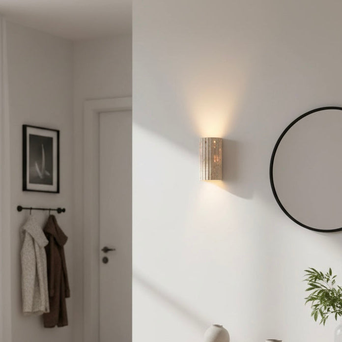 Elegant indoor wall sconce with a distinctive textured surface & soft, warm LED light.