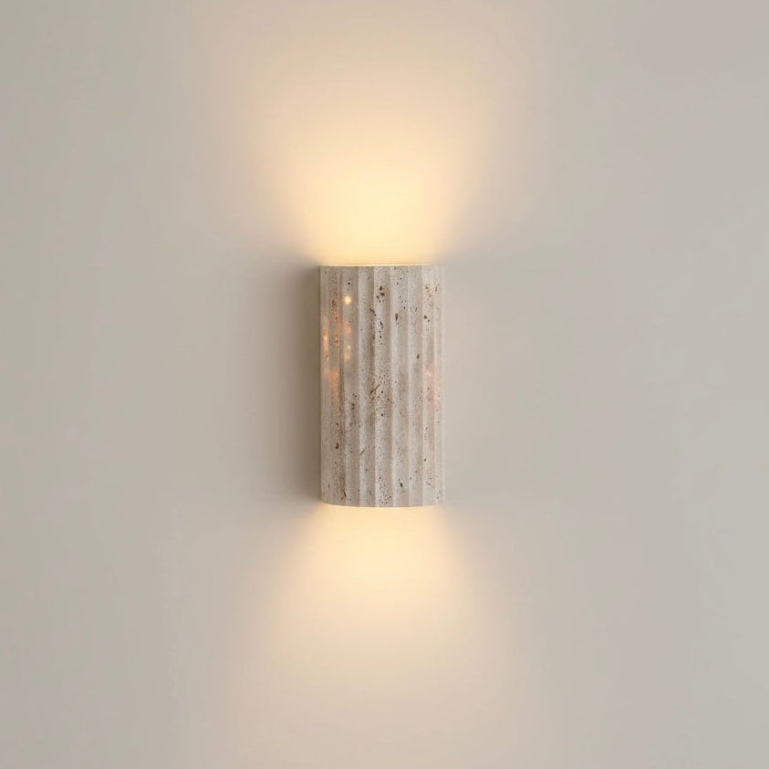 Textured indoor wall sconce, energy-efficient warm LED. Ideal for modern minimalist interiors.