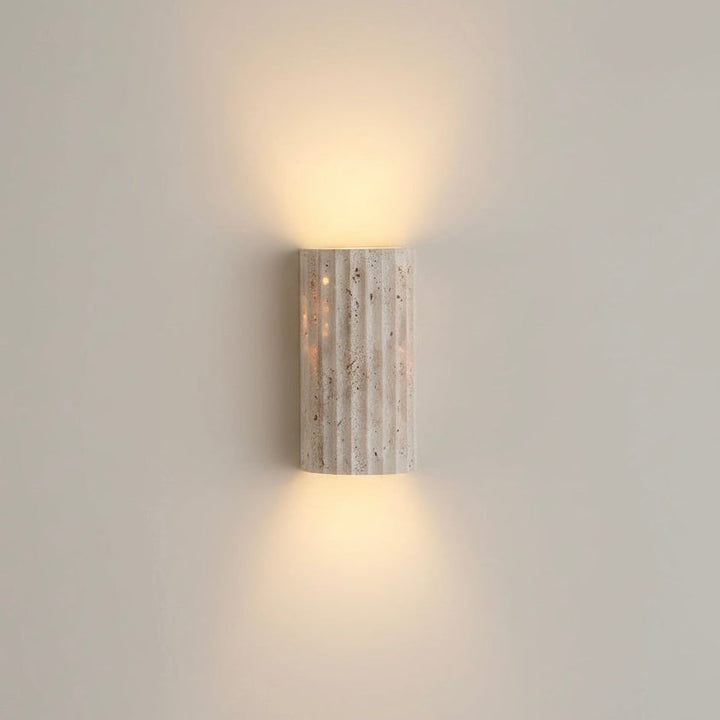 Textured indoor wall sconce, energy-efficient warm LED. Ideal for modern minimalist interiors.