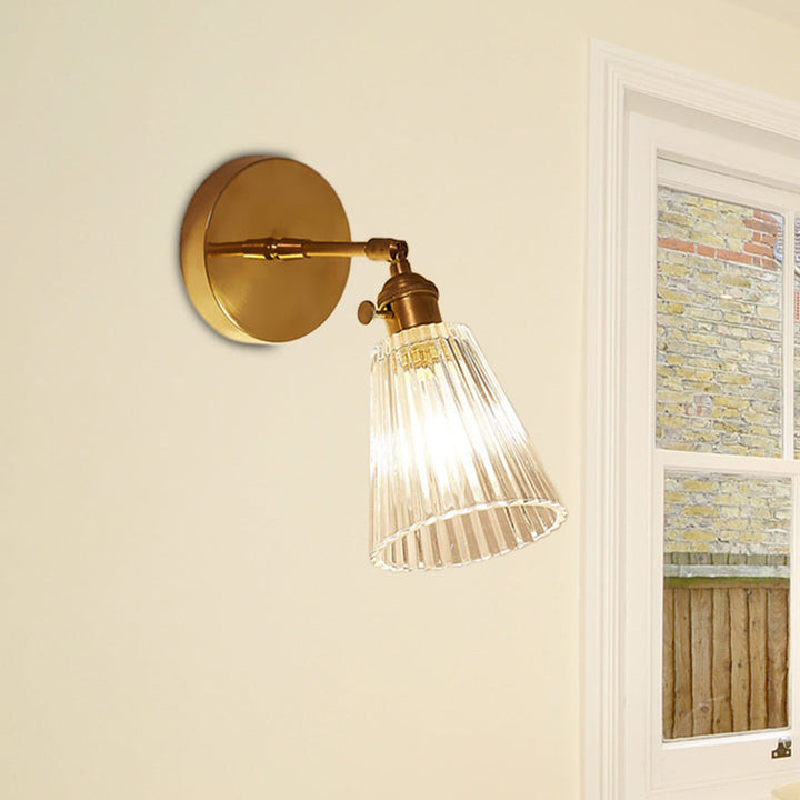 Stylish industrial brass wall sconce, single tapered glass light, perfect home lighting for kitchen or entryway.