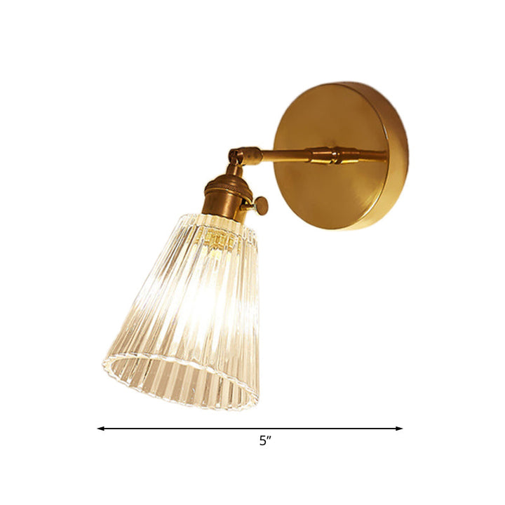 Home lighting: Industrial brass wall sconce with tapered clear glass shade, single light, modern kitchen accent.