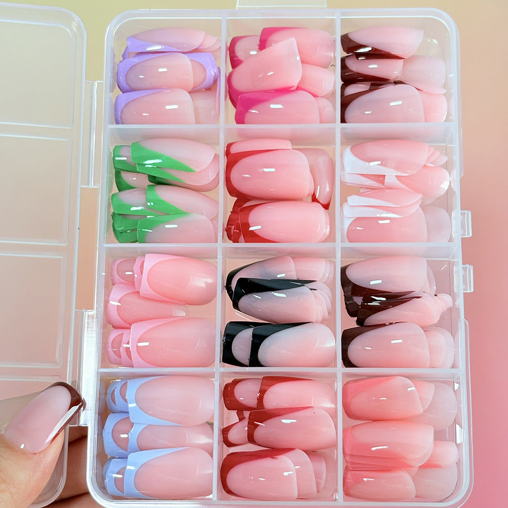 Woman applying chic green press-on nails, a reusable false nail art solution for quick & easy home manicures.