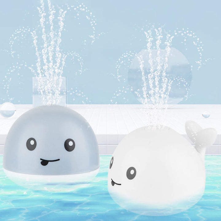 Toddler water play whale toy with LED lights & music. A safe, interactive bath time sprinkler for sensory development.