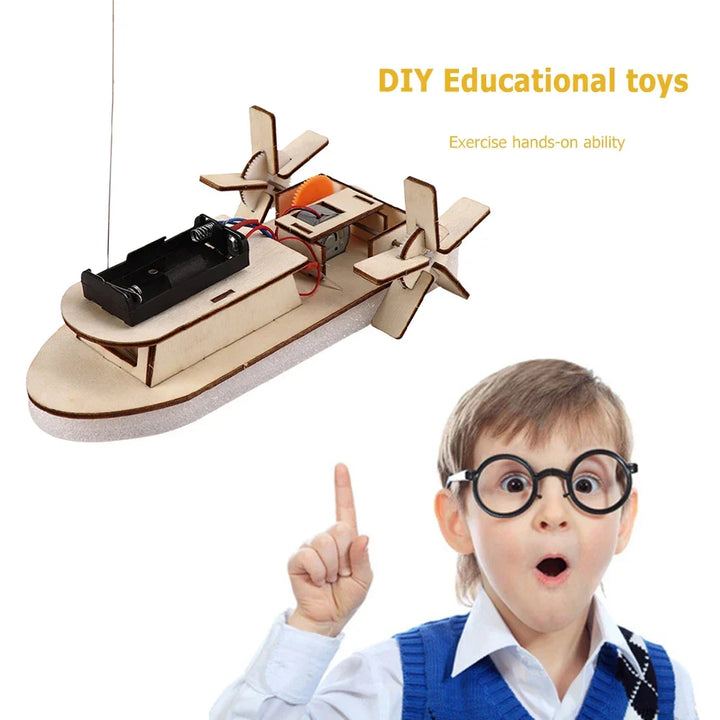 Child playing with a completed electric wooden toy boat in water. Fun DIY science kit for kids.