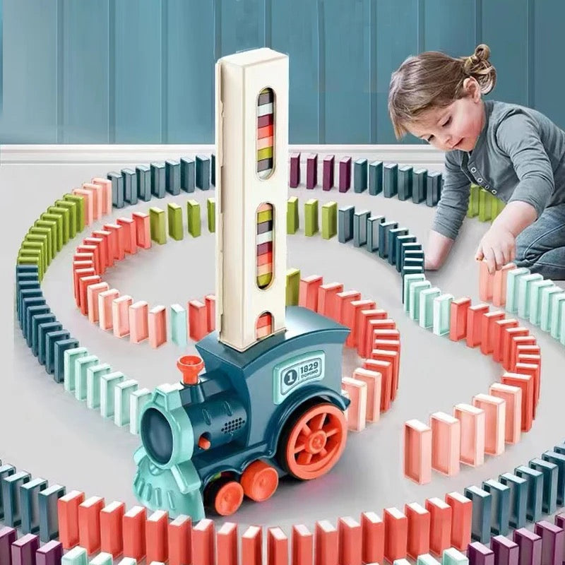Kids' Automatic Domino Train Toy with Lights & Sound, setting up a colorful domino chain for creative play.