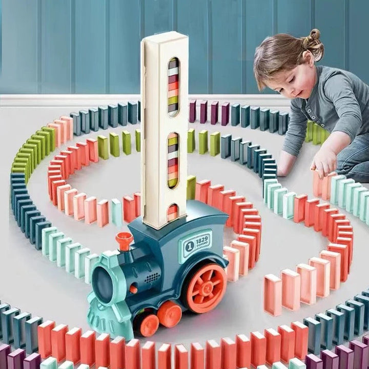 Kids' Automatic Domino Train Toy with Lights & Sound, setting up a colorful domino chain for creative play.
