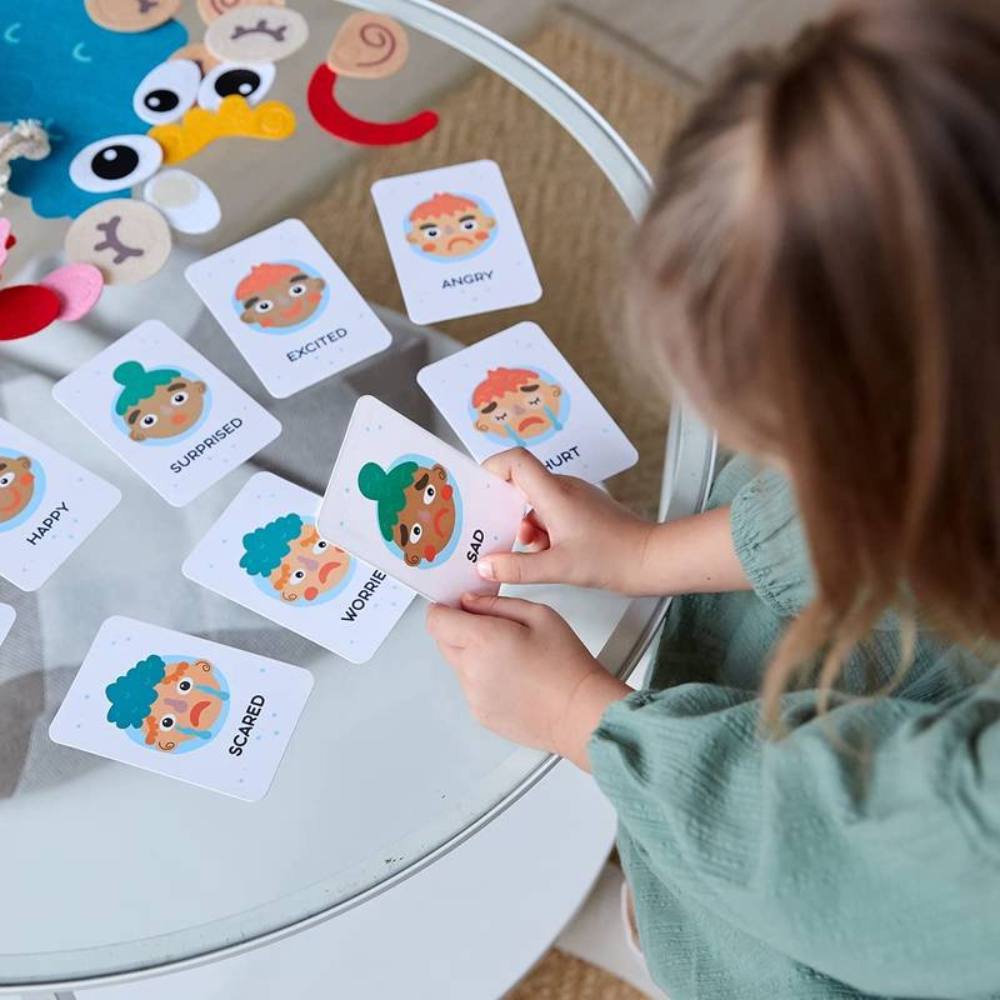 Colorful felt Montessori toy helps kids learn facial expressions & emotions. Great for creative play & early social skills.