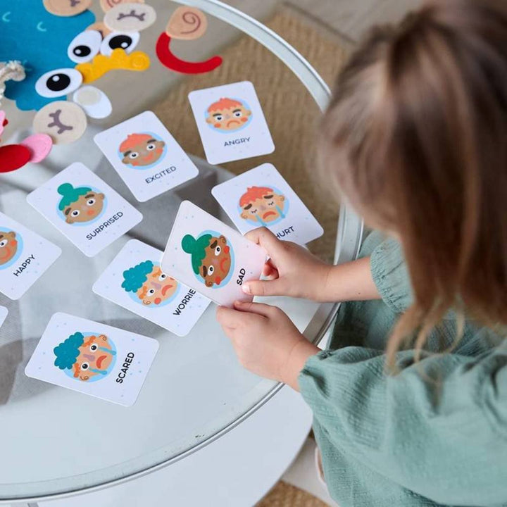 Colorful felt Montessori toy helps kids learn facial expressions & emotions. Great for creative play & early social skills.