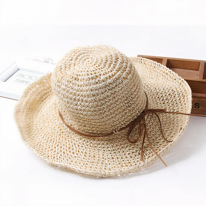 Stylish ladies' wide brim straw beach hat, ideal for summer travel and UV sun protection. Woven design.